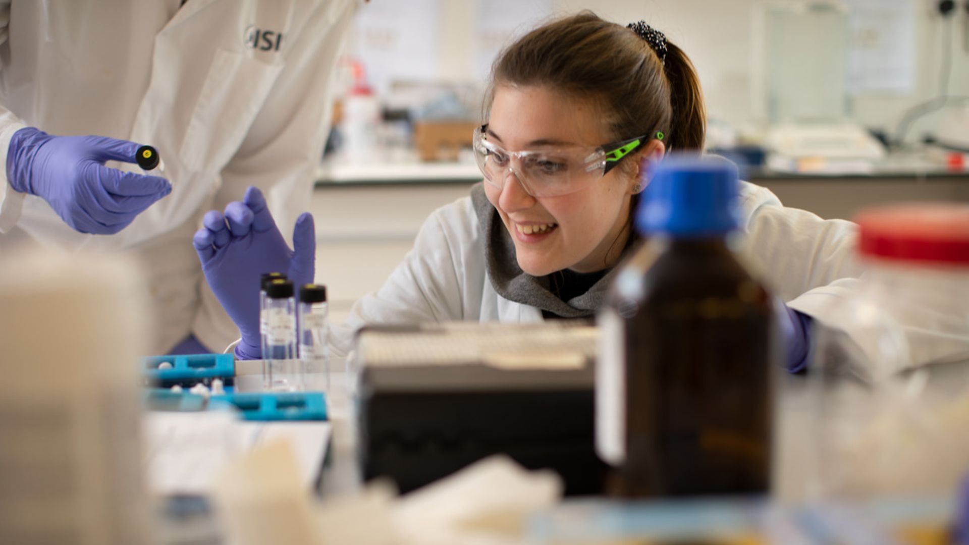 Researcher in safety glasses in laboratory environment