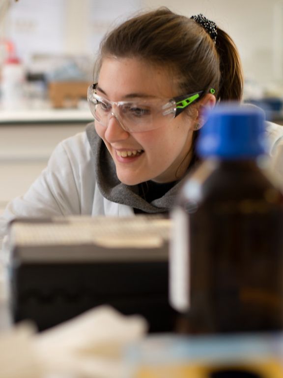 Researcher in safety glasses in laboratory environment